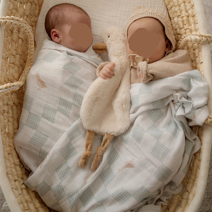 Neutral newborn baby swaddles with soft goose print muslin wraps and plush comforter toy