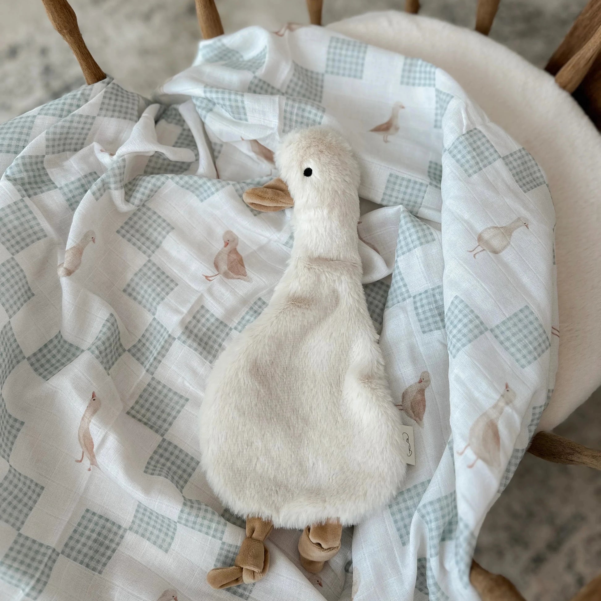 Neutral goose muslin baby swaddle with soft plush comforter toy for newborns