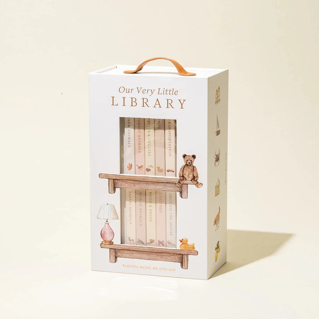 Box packaging for 'Our Very Little Library' with illustrations of a shelf and teddy bear on a beige background.