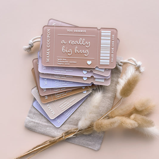 Stack of pastel mum coupon cards with voucher text and dried florals on neutral background
