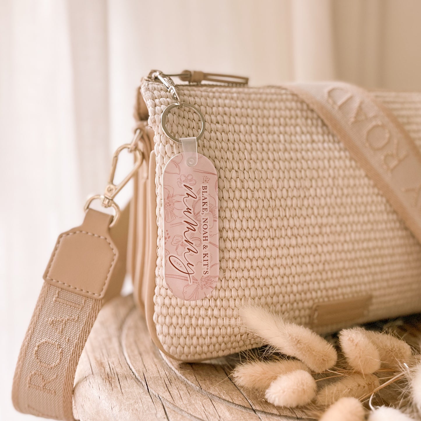 Personalised acrylic keychain by Salt And Pine Store attached to handbag
