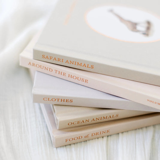 Stack of books on a white surface with titles visible