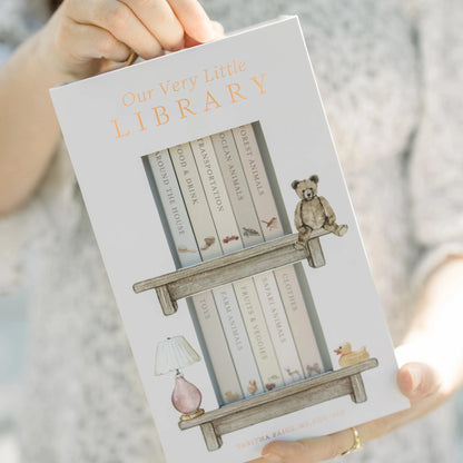 Book titled 'Our Very Little Library' held by a person